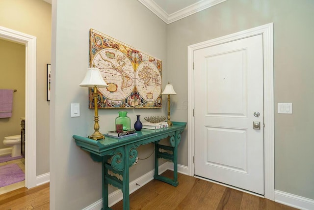 entryway featuring hardwood / wood-style floors and ornamental molding