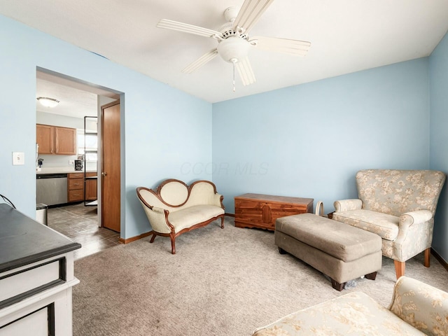 living area with ceiling fan and light carpet