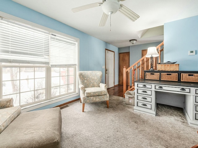 living area featuring carpet and ceiling fan