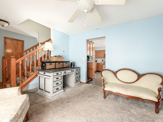 sitting room with ceiling fan and carpet floors