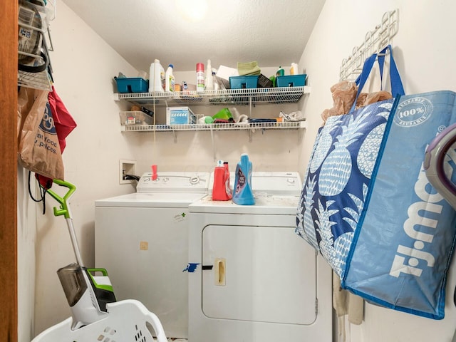 laundry area featuring washing machine and dryer and a textured ceiling