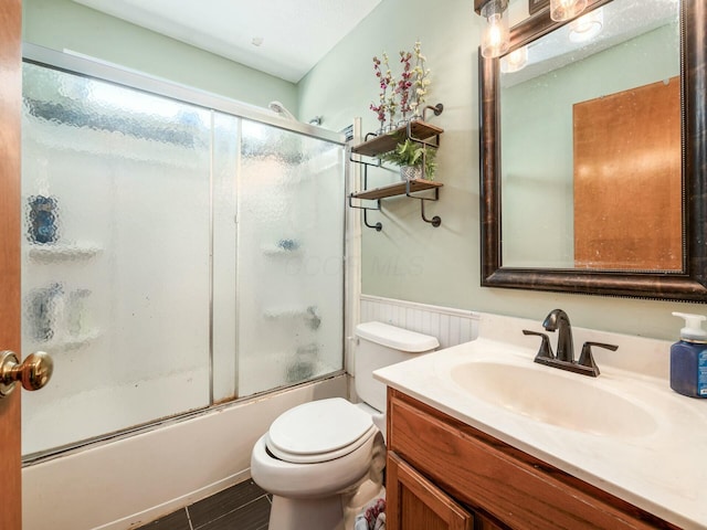 full bathroom with toilet, vanity, and combined bath / shower with glass door