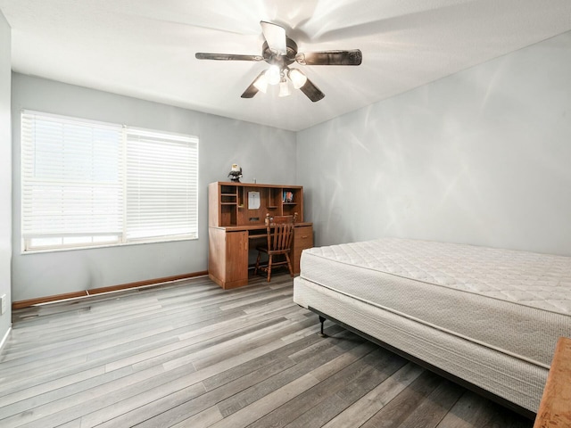 bedroom with light hardwood / wood-style flooring and ceiling fan