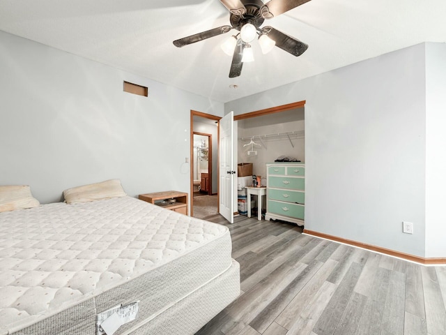 bedroom featuring ceiling fan, a closet, and wood-type flooring