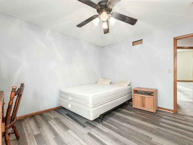 bedroom featuring hardwood / wood-style floors and ceiling fan