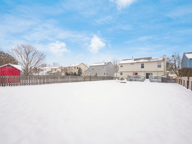 yard layered in snow featuring a wooden deck