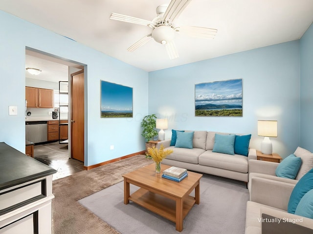 carpeted living room with ceiling fan