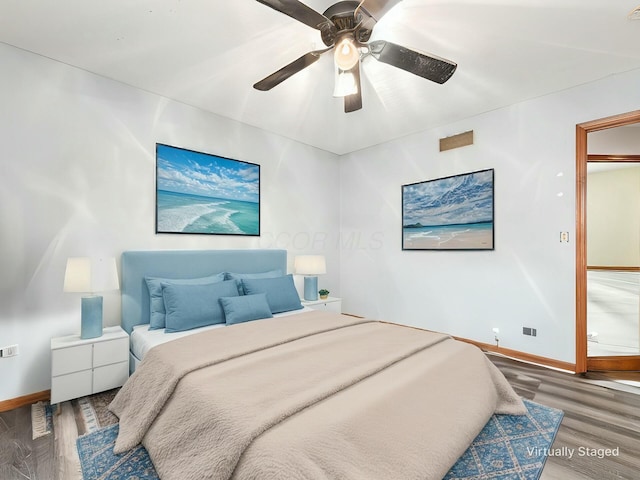 bedroom with ceiling fan and dark hardwood / wood-style flooring