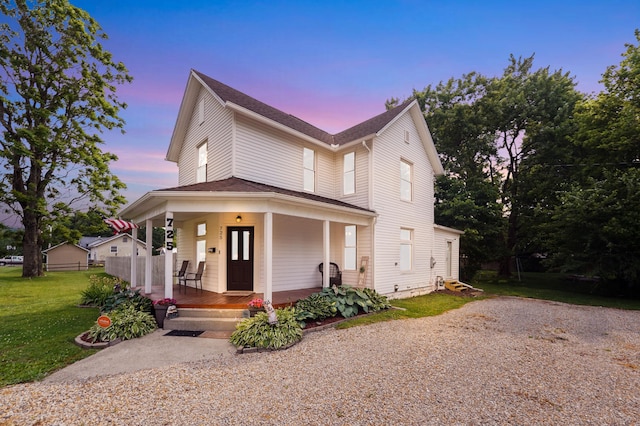 view of front of house with a lawn and covered porch