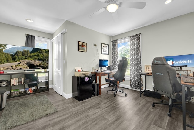 office area featuring wood-type flooring, plenty of natural light, and ceiling fan