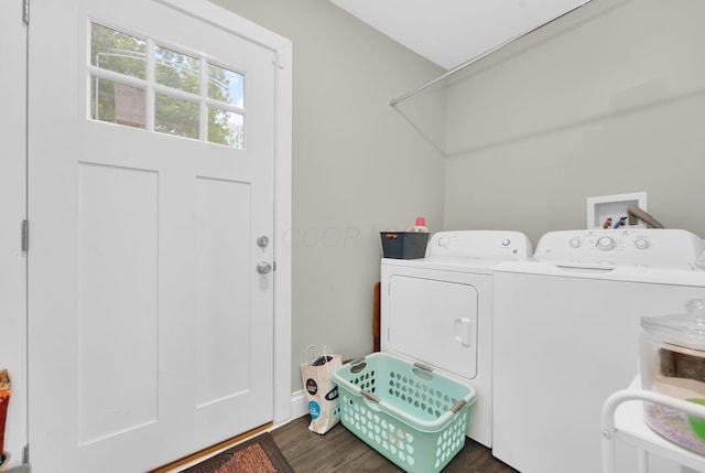 laundry area with washing machine and dryer and dark wood-type flooring