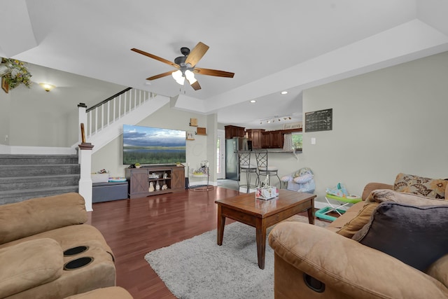 living room with dark hardwood / wood-style floors and ceiling fan