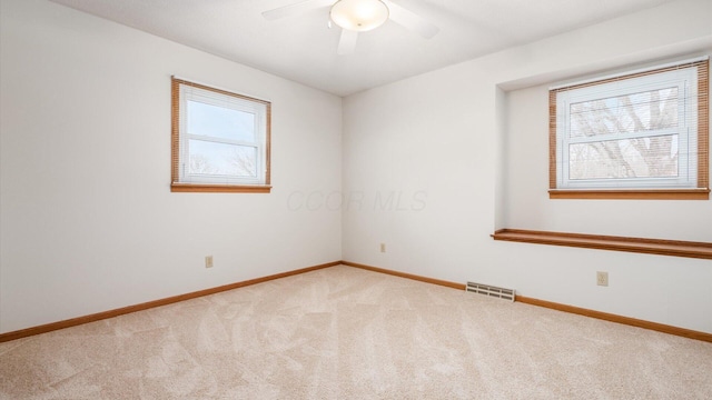 carpeted empty room featuring ceiling fan