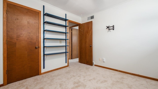 unfurnished bedroom featuring light carpet and ornamental molding