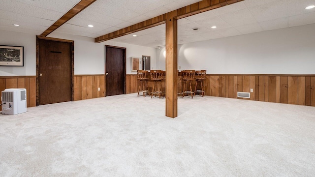 basement with carpet flooring and bar area