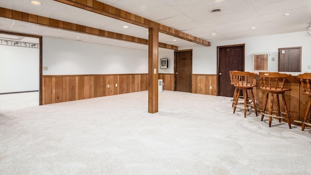 basement featuring carpet floors and bar