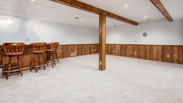 basement with bar area and carpet floors