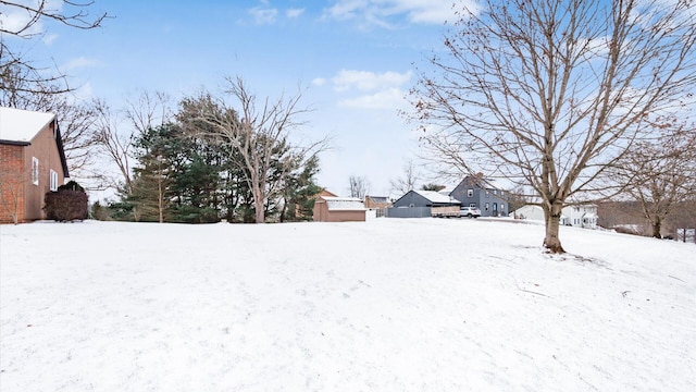 yard layered in snow with an outdoor structure