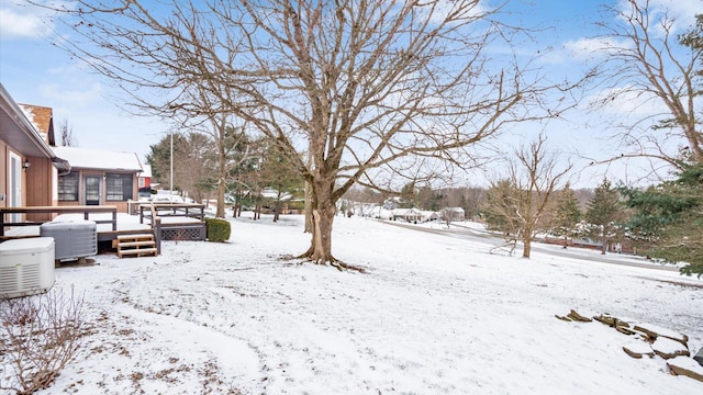 yard covered in snow featuring a deck