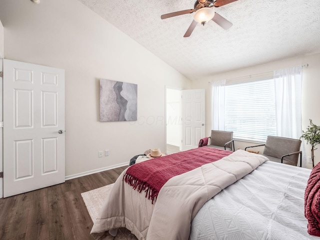 bedroom featuring dark hardwood / wood-style flooring, a textured ceiling, ceiling fan, and vaulted ceiling