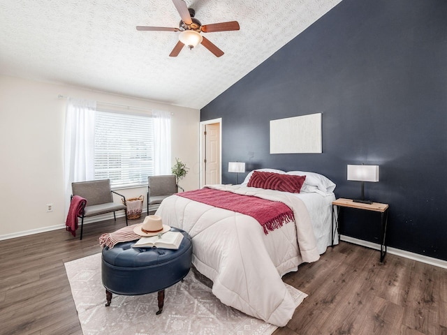 bedroom with ceiling fan, dark hardwood / wood-style flooring, lofted ceiling, and a textured ceiling