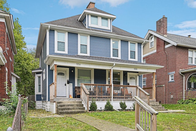 view of front of property featuring covered porch and a front lawn