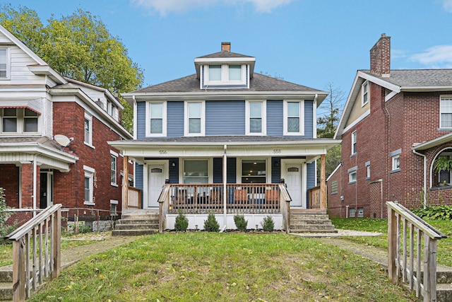 view of front of home featuring covered porch and a front yard