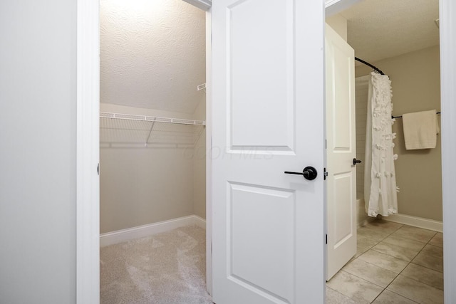 spacious closet with light tile patterned floors