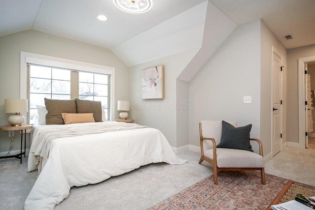 carpeted bedroom with lofted ceiling