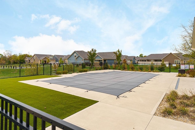 view of pool with a lawn and a patio