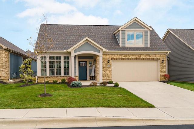 craftsman inspired home with a garage and a front lawn