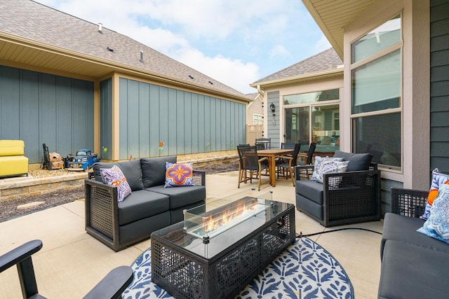 view of patio / terrace with an outdoor living space with a fire pit