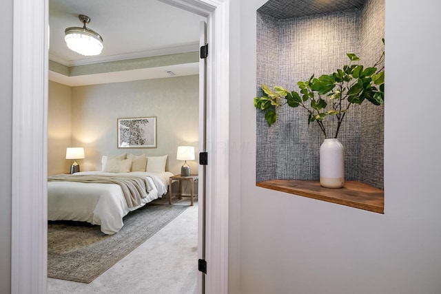 bedroom with light colored carpet and ornamental molding