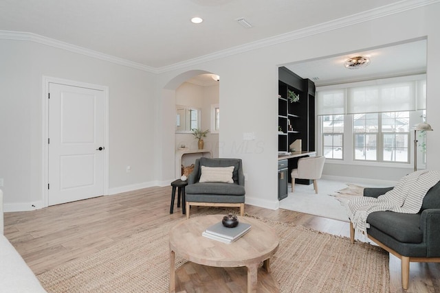 living room featuring light hardwood / wood-style flooring and ornamental molding