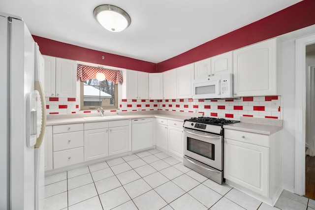 kitchen featuring white cabinets, white appliances, backsplash, and sink