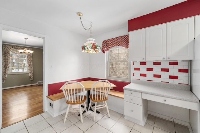 tiled dining space featuring an inviting chandelier