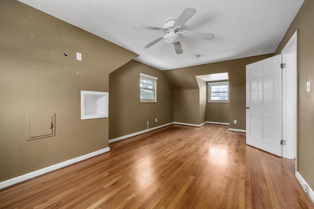 additional living space featuring light wood-type flooring, ceiling fan, and lofted ceiling