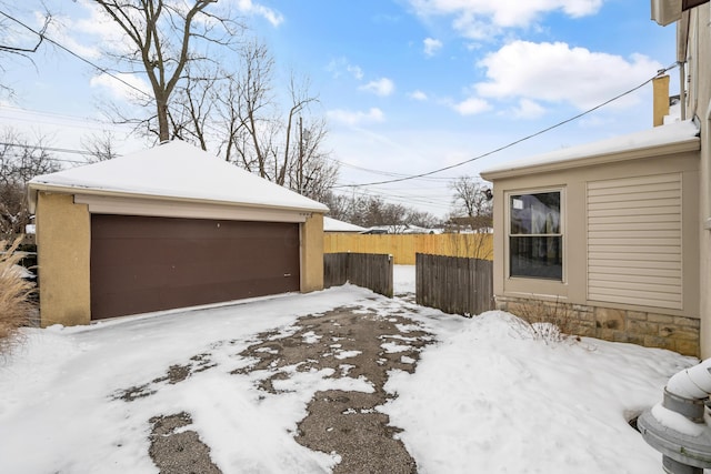 exterior space featuring a garage and an outbuilding