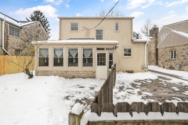 view of snow covered back of property