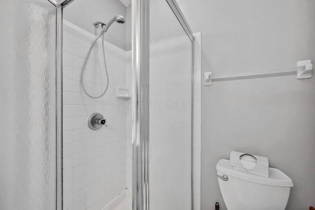 bathroom with toilet and walk in shower