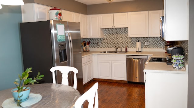 kitchen featuring sink, white cabinetry, stainless steel appliances, and dark wood-type flooring