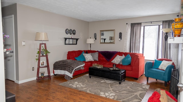 living room featuring a textured ceiling and dark wood-type flooring