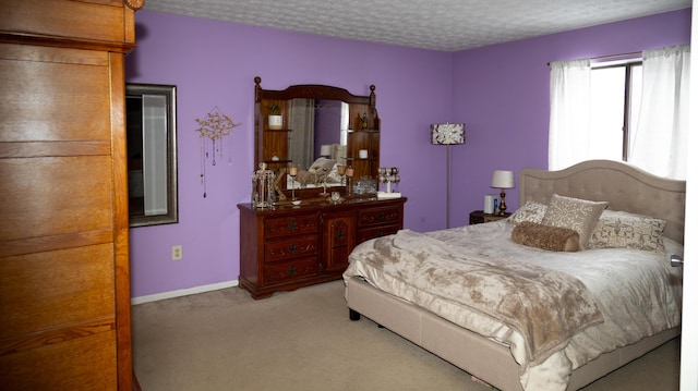 bedroom featuring a textured ceiling and light carpet