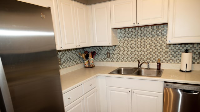 kitchen with white cabinetry, appliances with stainless steel finishes, and tasteful backsplash