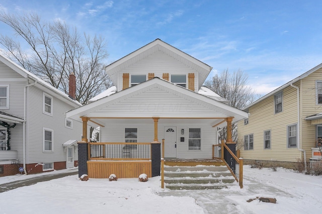 bungalow-style house with a wall mounted air conditioner and a porch