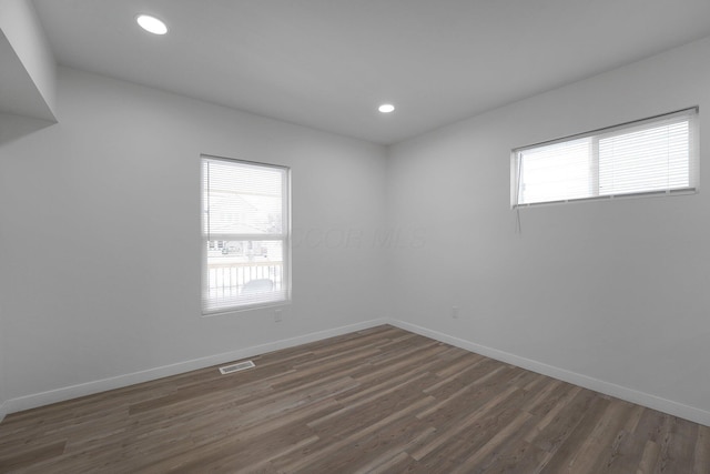 spare room with dark hardwood / wood-style flooring