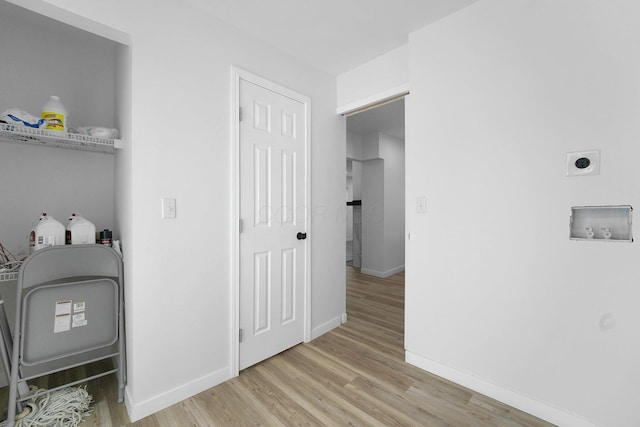 laundry area featuring hookup for a washing machine, light hardwood / wood-style flooring, and electric dryer hookup