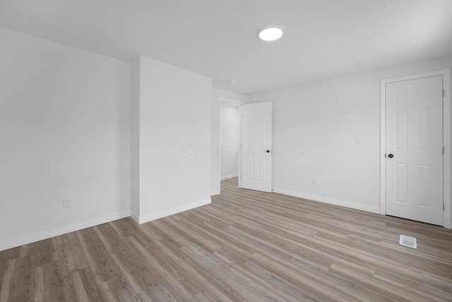 empty room with light hardwood / wood-style floors