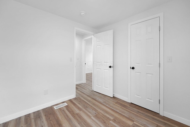 unfurnished bedroom with light wood-type flooring