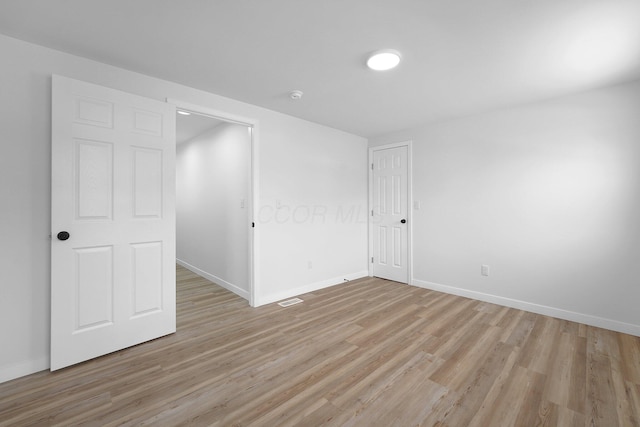 spare room with light hardwood / wood-style flooring